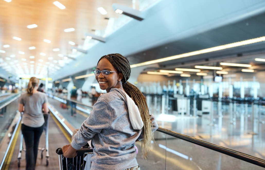 young african lady at departures for international travel